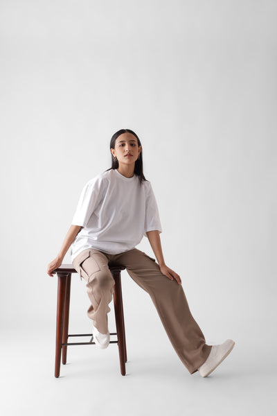 Classic oversized white tshirt for women - sitting on a chair front view full - unbound crew