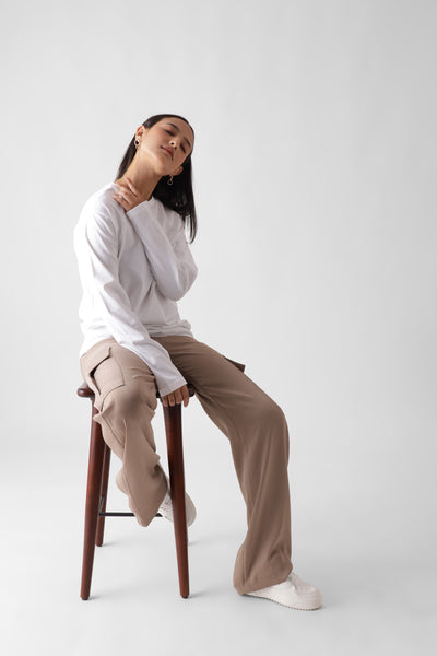 Classic long sleeve white tshirt for women - front view sitting on a chair full - unbound crew