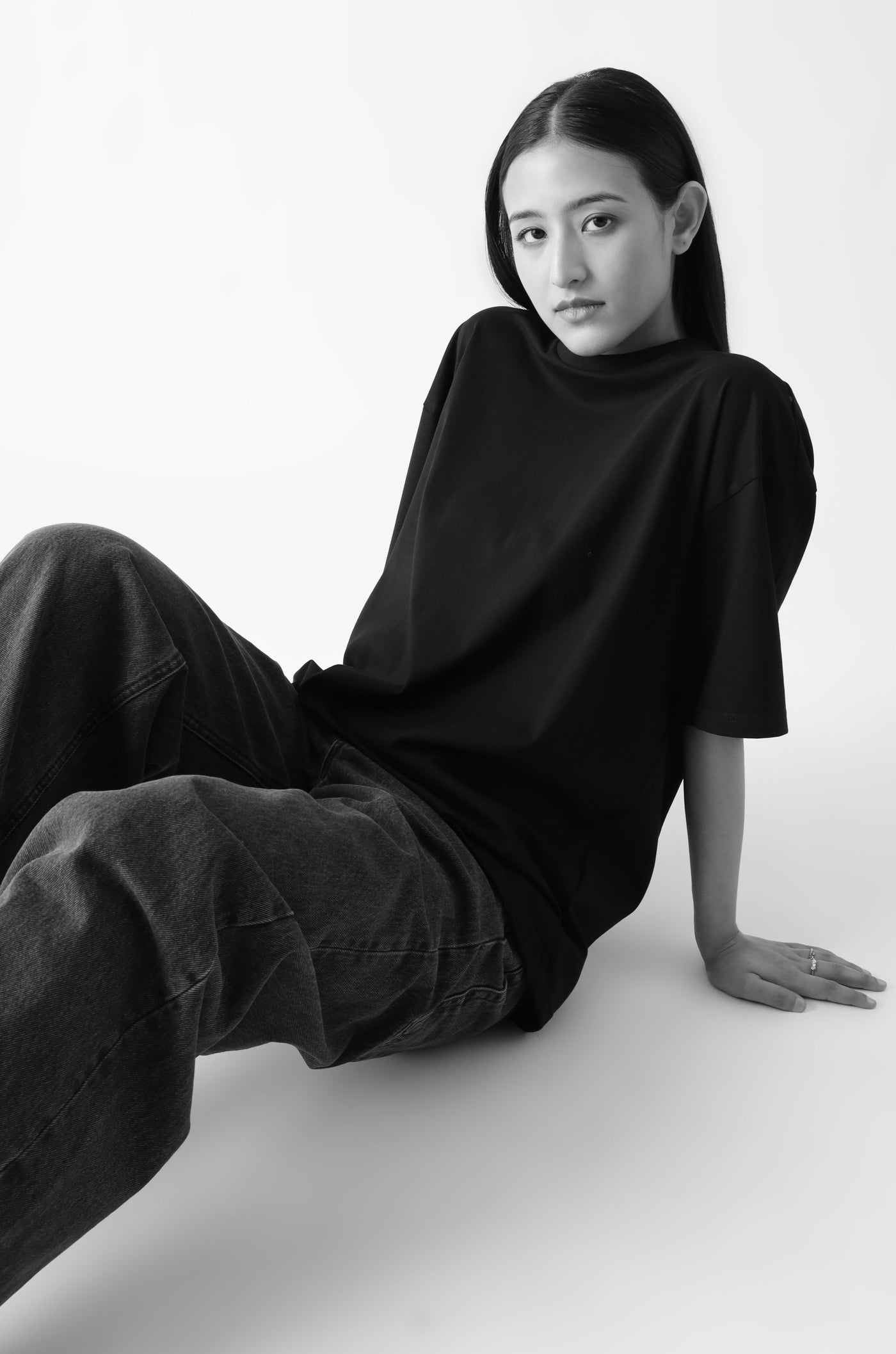 Classic oversized black tshirt for women - sitting on the floor - unbound crew