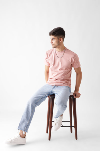 Classic half sleeve dust pink tshirt for men - sitting on a chair - unbound crew