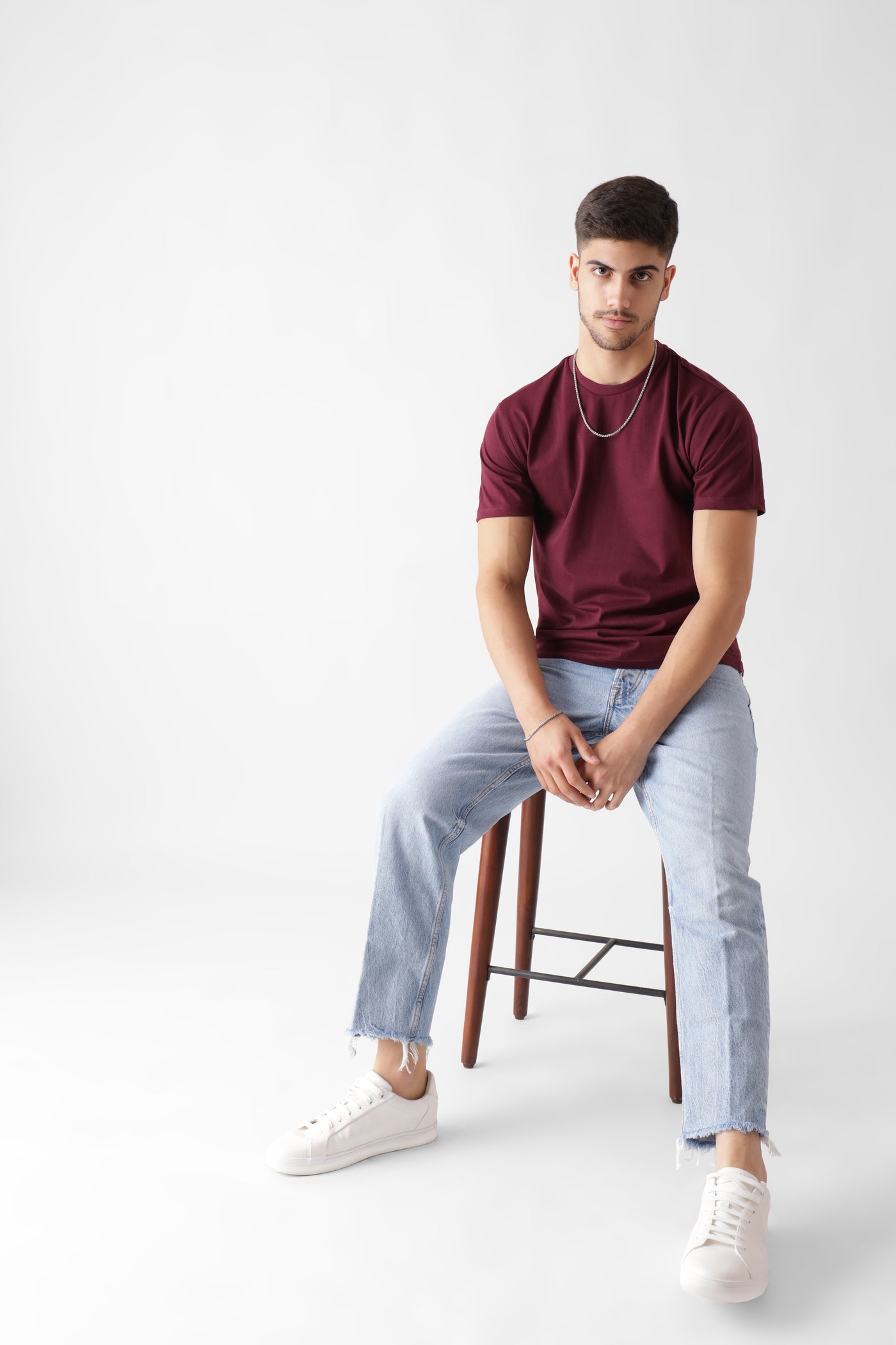 Classic half sleeve wine tshirt for men - sitting on a wooden chair - unbound crew