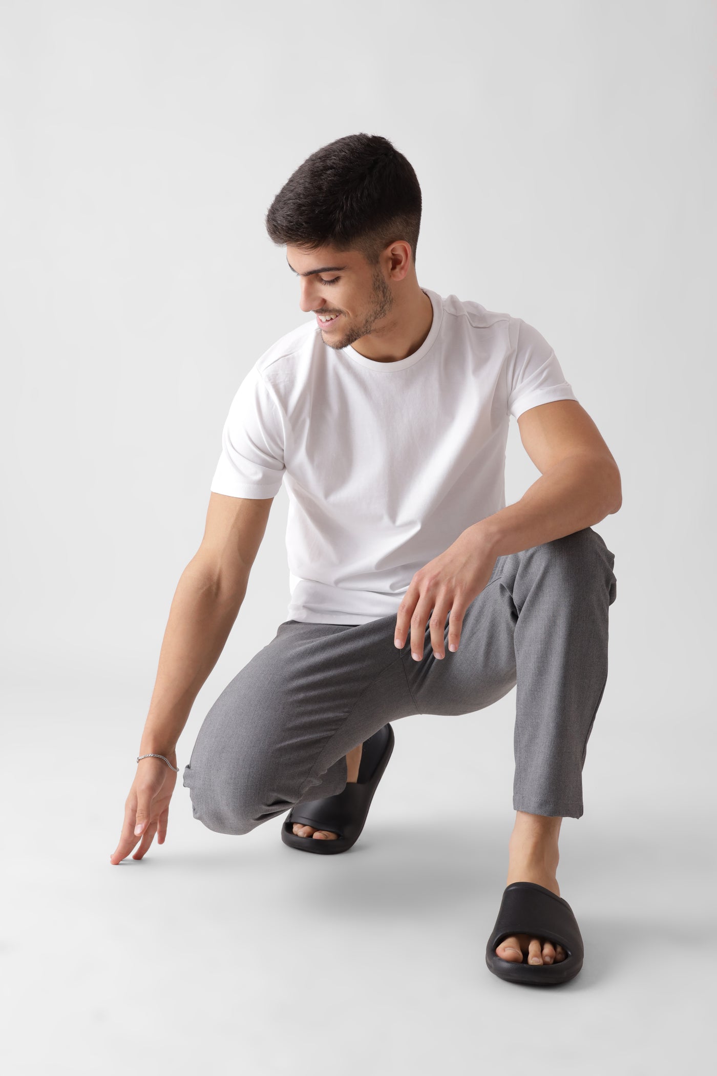 Classic half sleeve white tshirt for men - sitting down hand touching floor - unbound crew