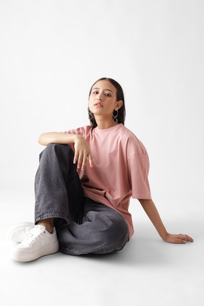 Classic oversized dust pink tshirt for women - sitting on the floor - unbound crew