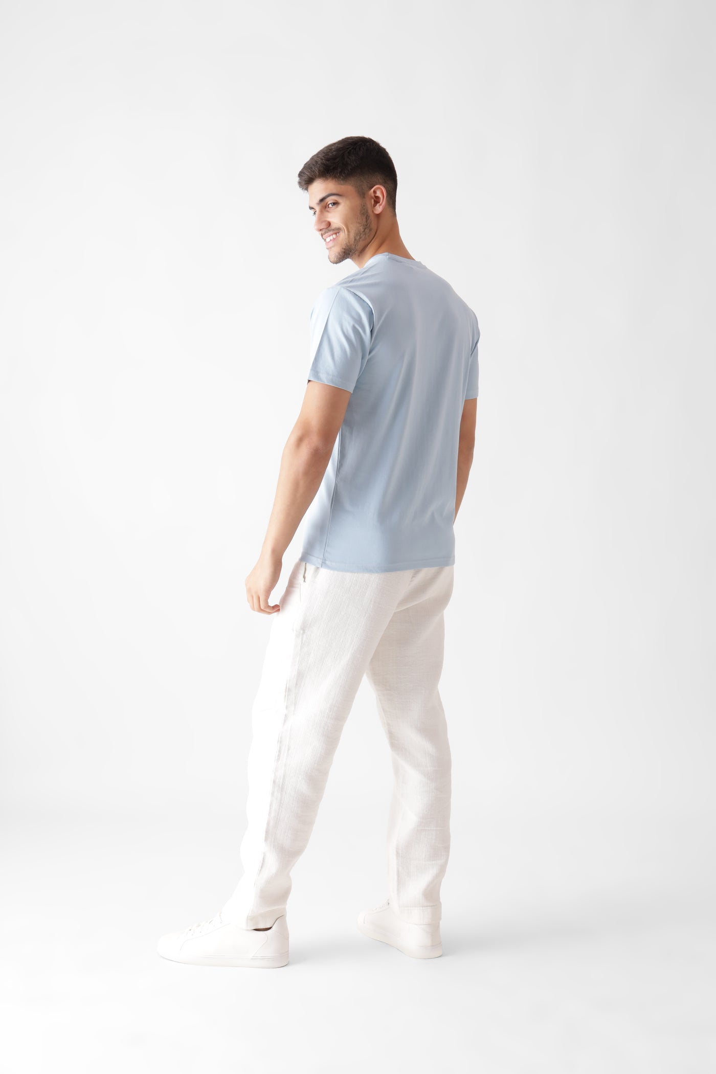 Classic half sleeve ice blue tshirt for men - looking back smiling back view - unbound crew