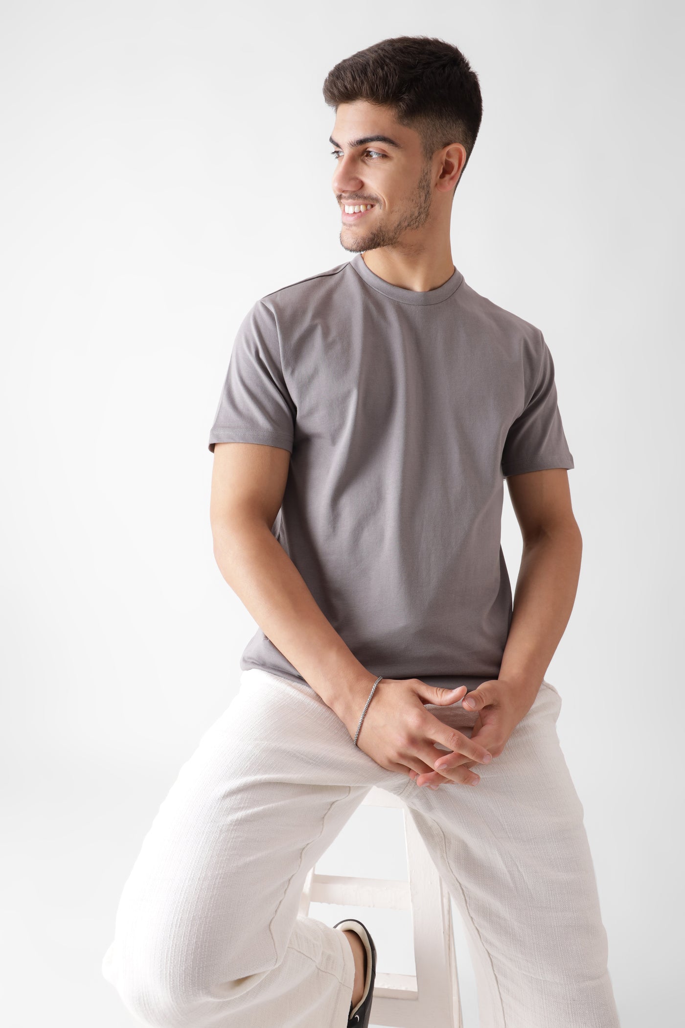 Classic half sleeve grey tshirt for men - sitting on a chair - unbound crew