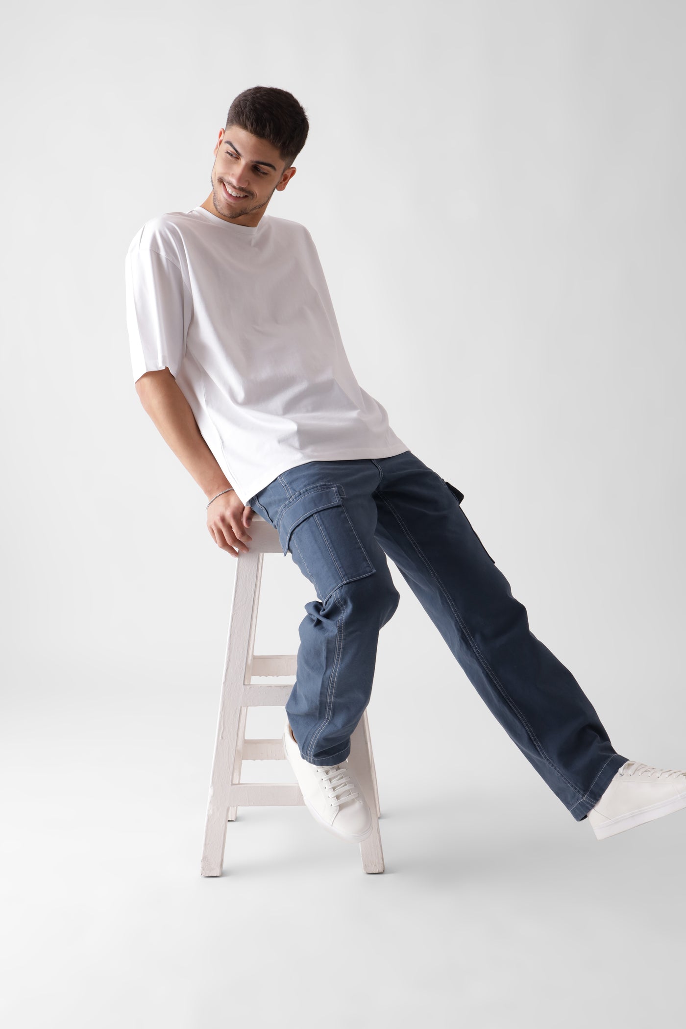 Classic oversized white tshirt for men - sitting on a chair - unbound crew