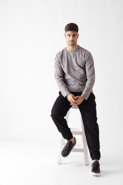 Classic long sleeve grey tshirt for men - sitting on a chair - unbound crew