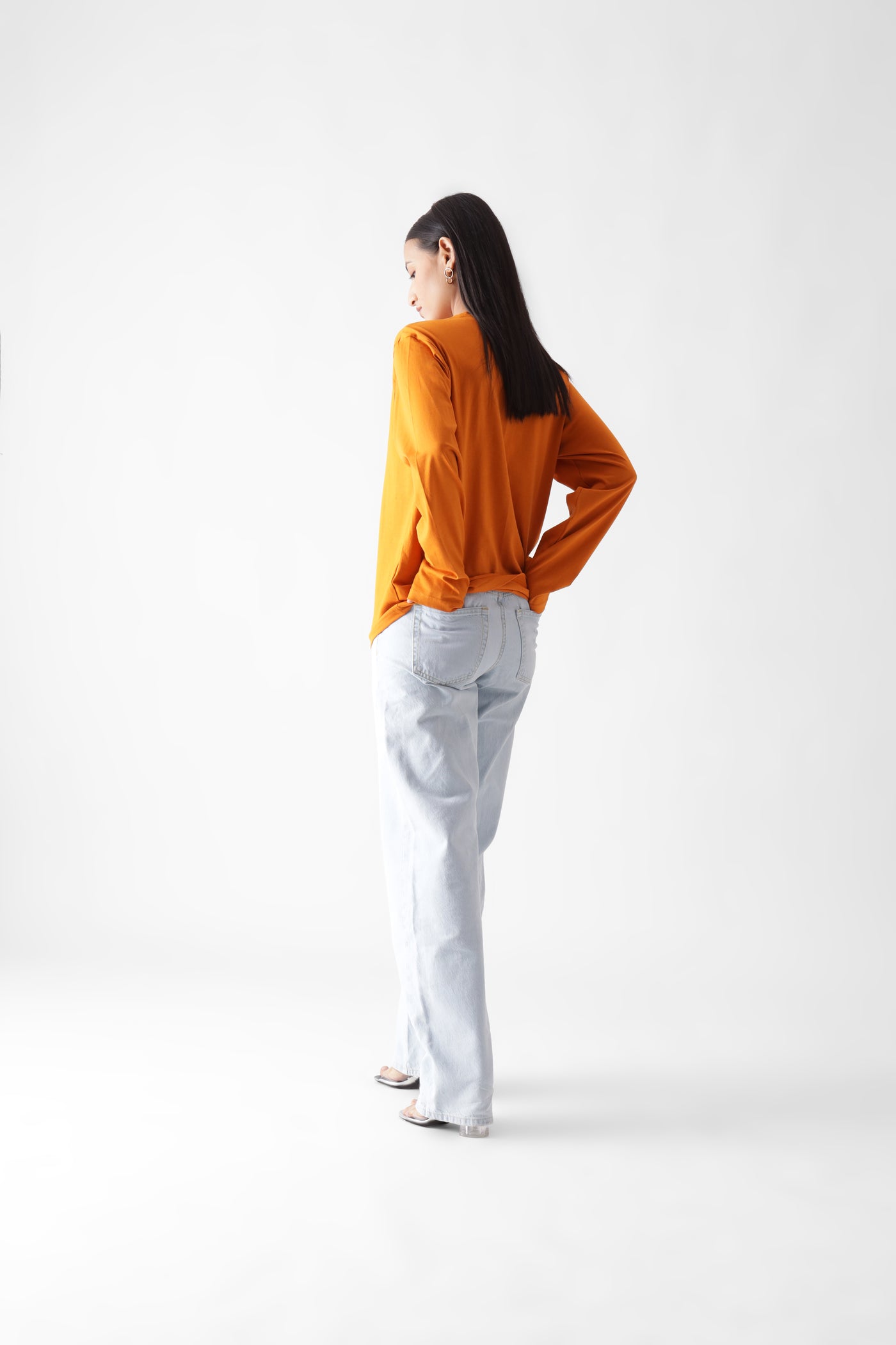 Classic long sleeve orange tshirt for women - hands in back pocket back view full  - unbound crew